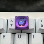 A detailed side view of the mischievous Gengar titanium keycap, emphasizing its low-profile artistry and the premium, intricately sculpted titanium angles.