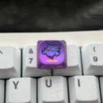 Mischievous Gengar Titanium Keycap, showcasing its intricate low-profile artistry from various angles. A premium sculpted titanium alloy keycap for esc key.