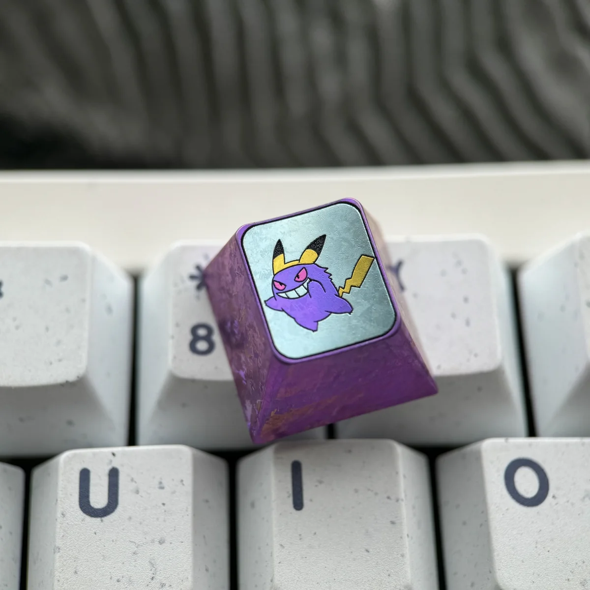 Close-up of the premium Gengar Titanium Artisan ESC Keycap, showcasing its intricate craftsmanship and dark whimsical design from multiple angles.