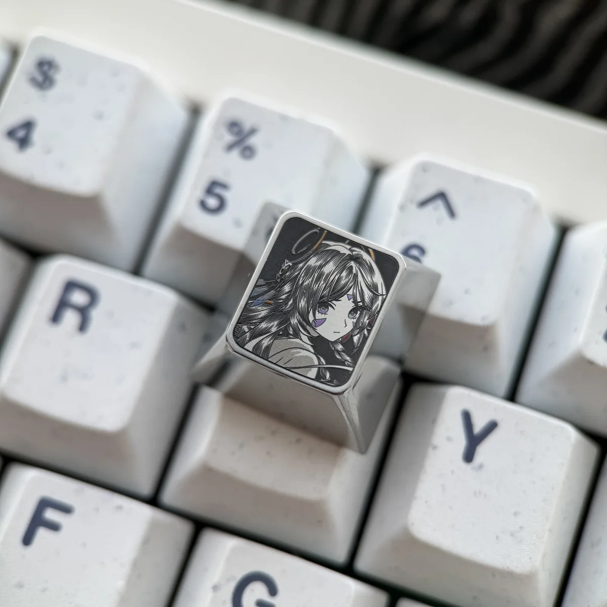 Vibrant Genshin Impact titanium artisan keycaps, precision-engraved with character portraits and pointillist detail, viewed from various angles.