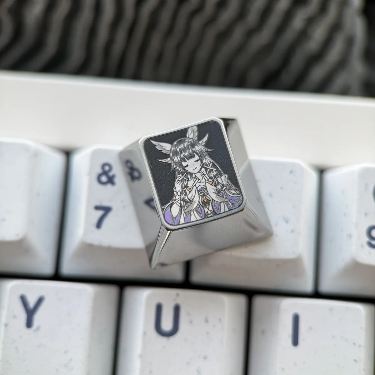 Detailed views of Genshin Impact titanium artisan keycaps from the directional set, highlighting vibrant, precision-engraved character portraits.