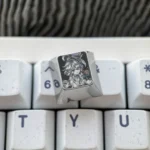 Artistic gallery of Genshin Impact titanium artisan keycaps, highlighting intricate character designs and polished titanium craftsmanship from multiple angles.