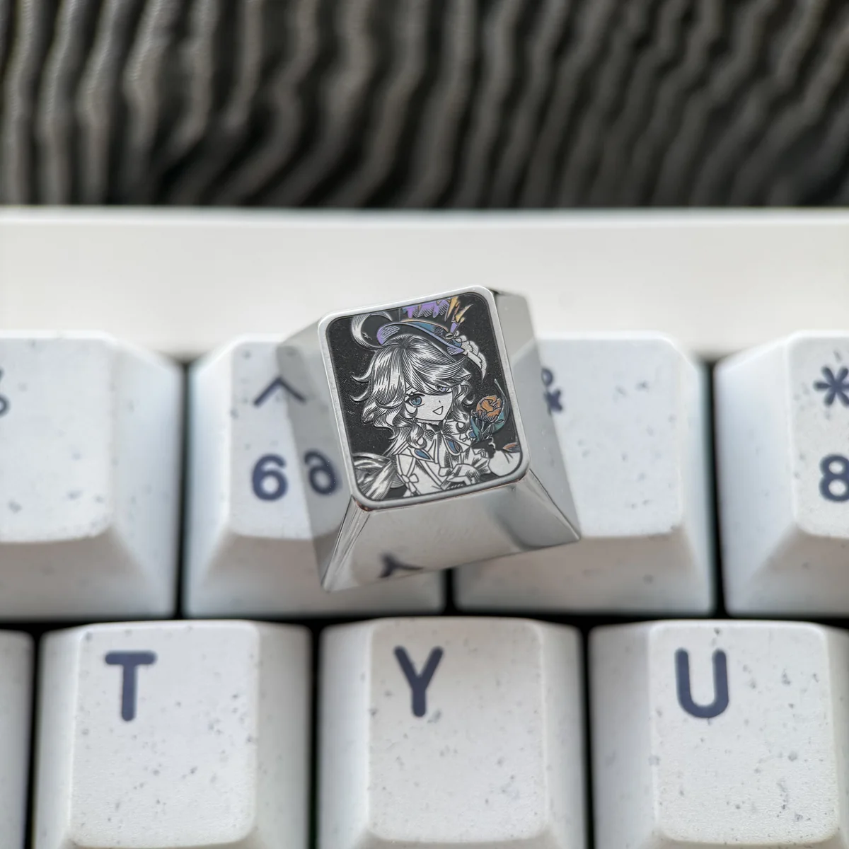 Artistic gallery of Genshin Impact titanium artisan keycaps, highlighting intricate character designs and polished titanium craftsmanship from multiple angles.