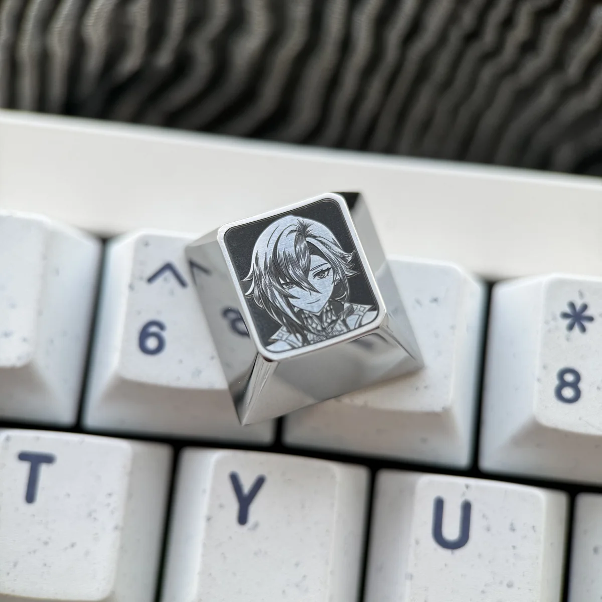 Detailed gallery showing vibrant Genshin Impact titanium artisan keycaps, featuring precision-engraved character portraits with artistic pointillist setup.