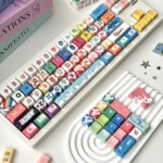 Vibrant Cat Candy Graffiti Keycap Set, a playful 134-key MDA mechanical keyboard art piece featuring dynamic cat and lollipop graffiti designs.