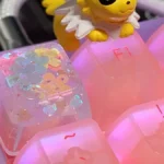 Multiple angles of a handcrafted luminous floral artisan keycap, showcasing vibrant encapsulated flowers within translucent resin for an ethereal design.