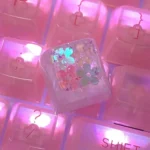 Handcrafted luminous floral keycap, a unique artisan ESC piece with vibrant encapsulated flowers set in translucent resin, creating an ethereal desktop.
