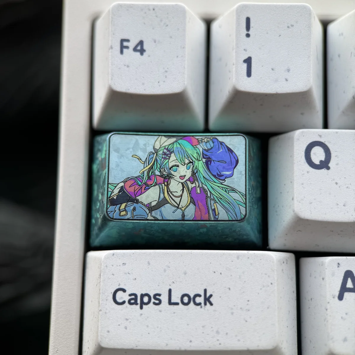 Premium Hatsune Miku keycap: a 1.5U Tab titanium artisan keycap, featuring iconic aesthetics and sleek, durable metallic artistry.