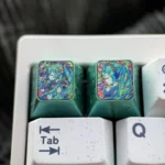 Iconic Hatsune Miku Titanium Artisan ESC keycap, showcasing its vibrant design and dynamic broken glass effect on lustrous titanium.