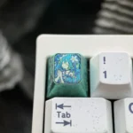 Vibrant Hatsune Miku titanium artisan ESC keycap, Theme Four, featuring a dynamic broken glass effect with an artistic, intense Miku portrayal.