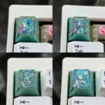 Vibrant Hatsune Miku titanium artisan ESC keycap featuring a dynamic broken glass effect on lustrous alloy, an iconic collectible for enthusiasts.