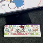Playful Hello Kitty Side-Printed Backlit PBT Keycaps Set, showcasing charming motifs and vibrant illuminated legends on a keyboard.