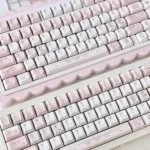 Charming Hello Kitty keycaps in a vibrant fashion blog set, shown from different angles, highlighting the complete, iconic collection.