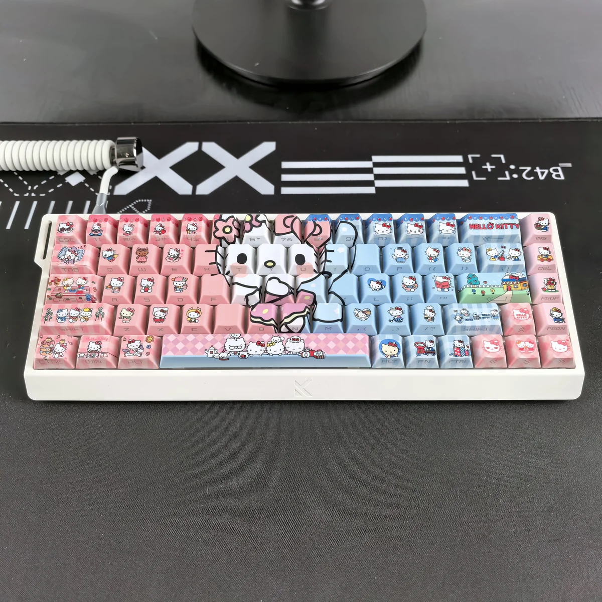 Close-up of Hello Kitty Keycaps Set showcasing the vibrant translucent PBT material and playful side-engraved designs from a unique angle.