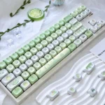 A playful close-up of the Honeydew Ice Cream MOA Keycap Set, showcasing soft pastel melon and vanilla tones. Dessert-inspired and refreshing setup.