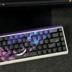 Close-up of a mischievous, glowing Gengar backlit artisan keycap set from a unique angle, highlighting its sculpted details and iconic setup.