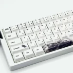 Dynamic Initial D PBT AE86 keycaps set displayed from various angles, highlighting iconic JDM racing designs and vibrant dye-sub details for a playful keyboard.