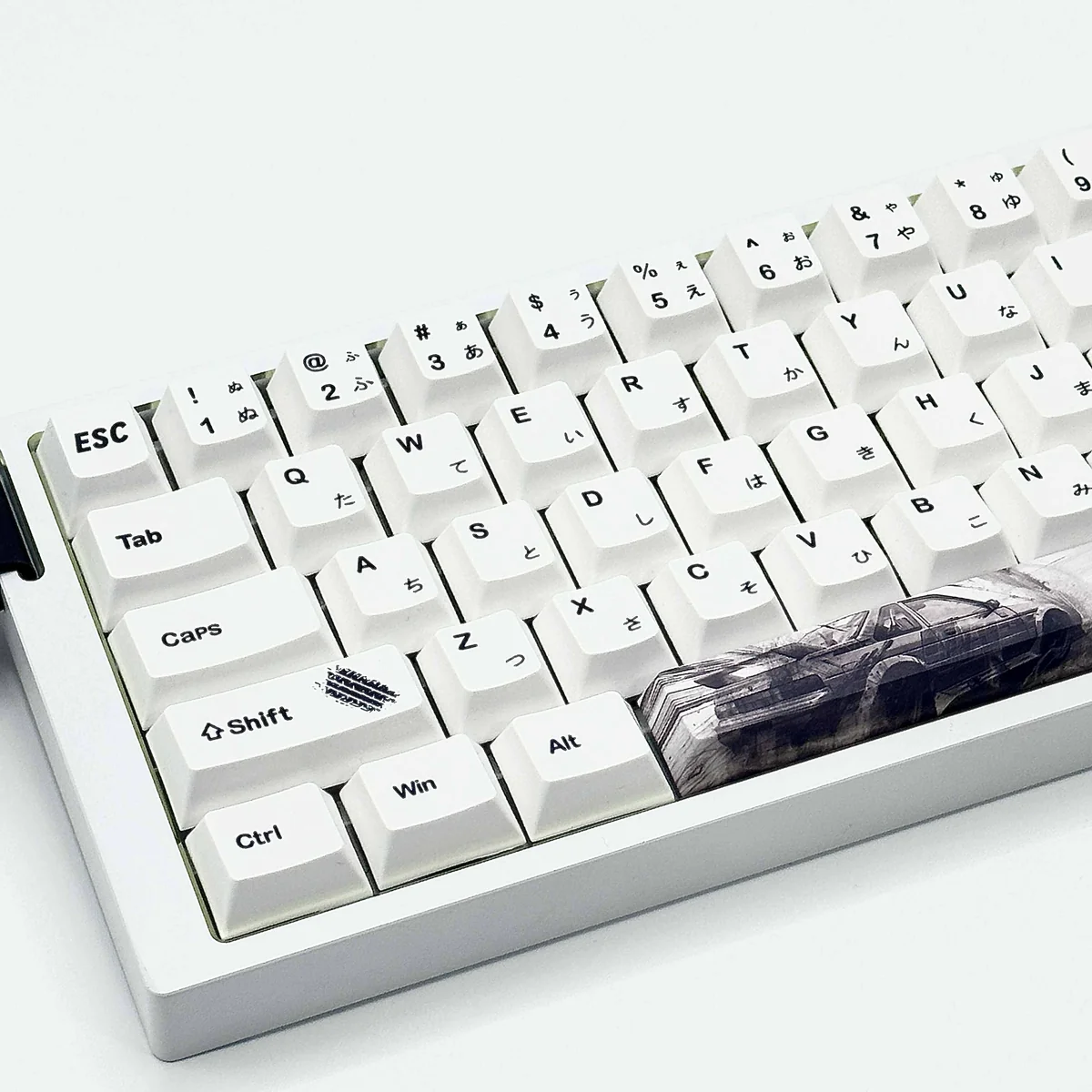 Dynamic Initial D PBT AE86 keycaps set displayed from various angles, highlighting iconic JDM racing designs and vibrant dye-sub details for a playful keyboard.