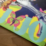 Close-up of the JoJo's Bizarre Adventure Desk Mat, highlighting the unique, vibrant art of Jolyne and Anasui in dynamic anime style.