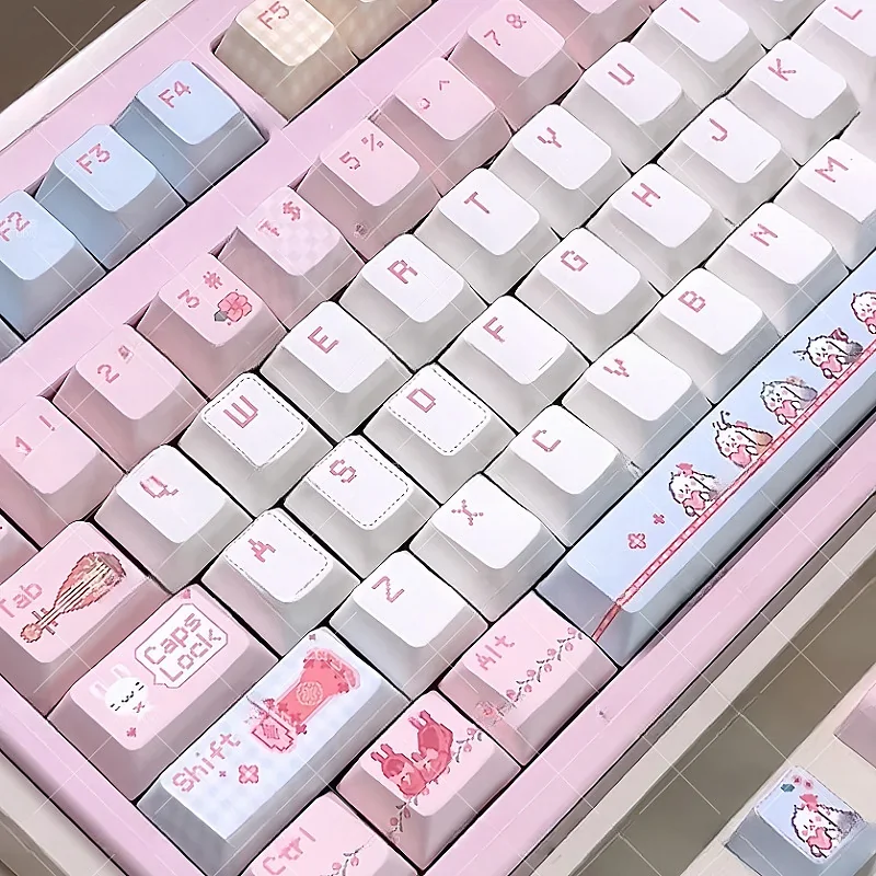 Artistic JX3 Qi Xiu pixel keycaps set, featuring exclusive JX Online 3 clan art. Charming pixel designs are seen from multiple angles, perfect for gaming setup.