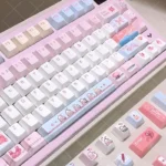 Artistic JX3 Qi Xiu pixel keycaps set displayed from various angles, highlighting exclusive JX Online 3 elegant clan designs and charming pixel aesthetics.