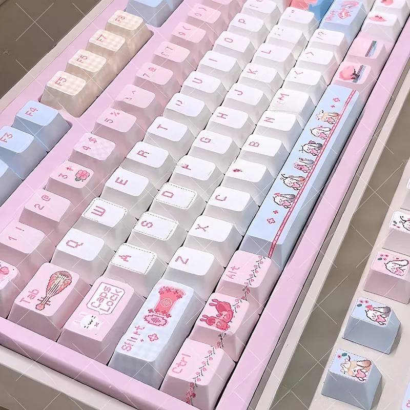 Close-up of the exclusive JX3 Qi Xiu pixel keycaps set, displaying charming pixel art and elegant Qi Xiu Clan aesthetics from various artistic angles.