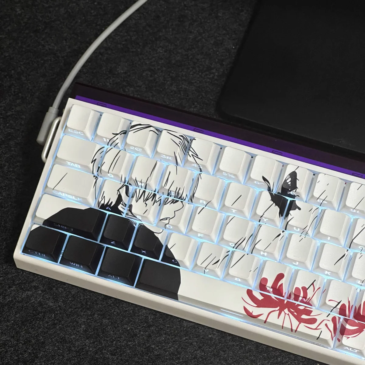 Ken Kaneki side-lit PBT keycaps set from a distinct angle, revealing the enigmatic glow of side-engraved legends and the dark anime aesthetic.