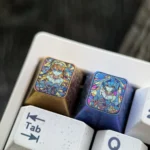 Close-up of the premium titanium Evangelion artisan keycap, highlighting the dynamic shattered glass design featuring Asuka and Rei's iconic imagery setup.
