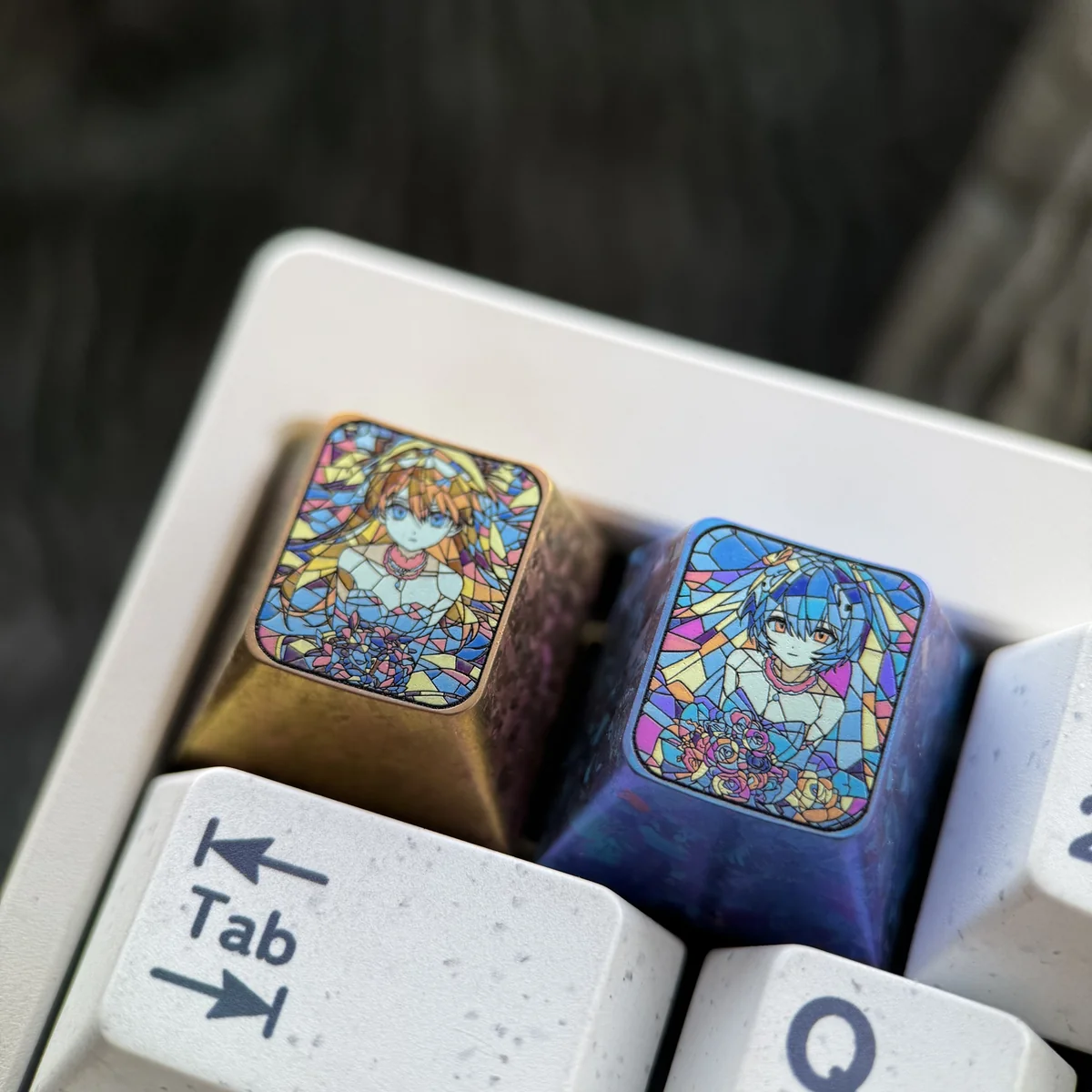 Close-up of the premium titanium Evangelion artisan keycap, highlighting the dynamic shattered glass design featuring Asuka and Rei's iconic imagery setup.