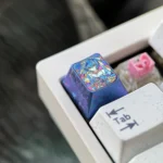 Premium Titanium Evangelion Asuka Rei artisan keycap, beautifully showcasing its dynamic broken glass design and lustrous finish from a distinct angle.