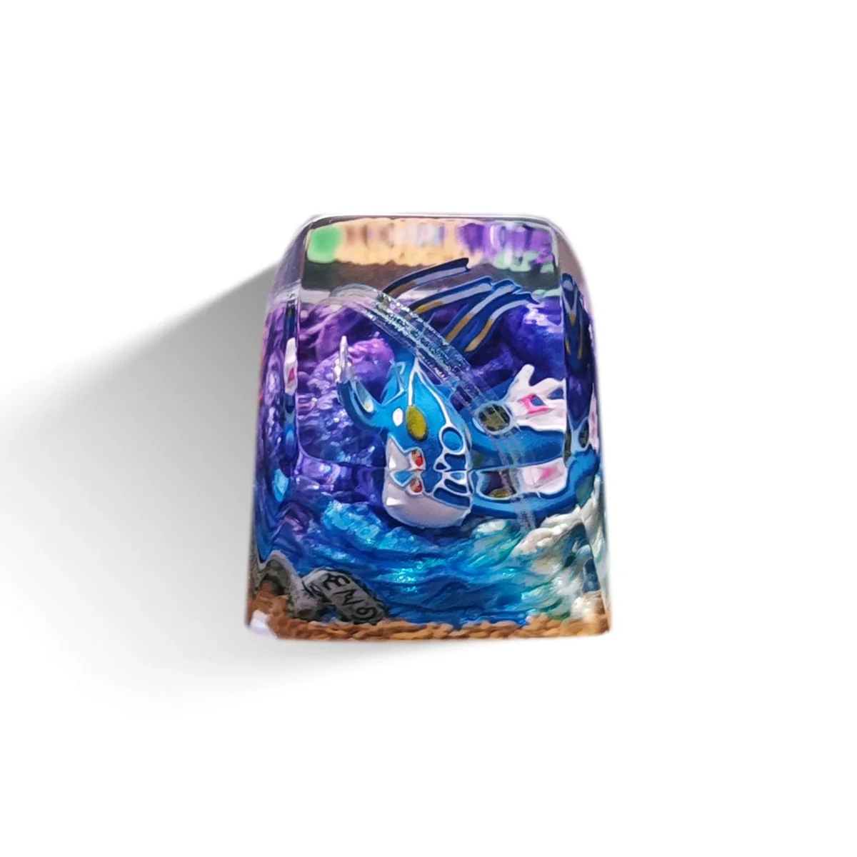A stunning handcrafted Kyogre Pokemon artisan keycap, showcasing deep ocean blues and a majestic legendary creature design as unique desktop art.