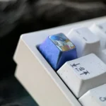 Angled view of the premium Mai Sakurajima titanium ESC keycap, showcasing its elegant sculpted anime art and brilliant metallic finish.