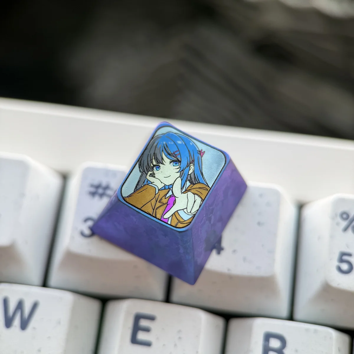 Mai Sakurajima titanium ESC keycap. Elite anime art collectible with elegant sculpting, intricate details, and metallic luster, viewed from various angles.