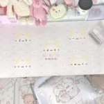 Top-down view of the extra-large pink whimsical marshmallow cat desk mat, showcasing its charming pastel design and adorable cat illustration.