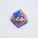 Close-up view of a vibrant, handcrafted Monster Hunter Palico keycap, showcasing its charming sculpted details and artistic SA R1 profile.