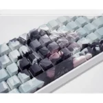 Close-up of NieR Automata 2B side-lit PBT keycaps set, showcasing dystopian elegance and intricate 2B character details from a unique angle.