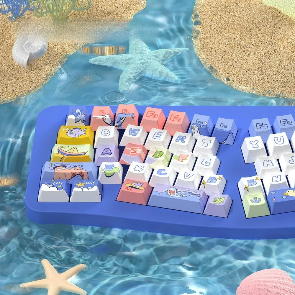 Serene ocean themed PBT dye-sub keycaps set. Multiple views reveal tranquil blue and white, subtle marine motifs, and gentle wave patterns.