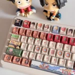 Vibrant One Piece Straw Hat PBT keycaps set showcasing the complete set from multiple angles, featuring playful characters and iconic symbols for an adventure feel.