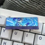 Premium titanium Overwatch Kiriko keycap, expertly crafted, shown from a dynamic angle, emphasizing its sleek metallic tribute and durable game aesthetics.