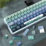 Close-up of the Serene Wind artistic PBT dye-sub keycap set, showcasing tranquil cloud motifs and gentle wind patterns in soothing colors for serene typing.
