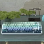 Artistic Serene Wind Dye-Sub PBT Keycap Set. Features tranquil natural landscapes, gentle wind, and cloud motifs. Soothing colors for serene typing.