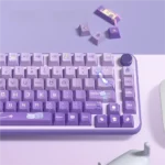 Close-up of enchanting Meow Castle Cat PBT keycaps set in taro purple, showcasing the whimsical dye-sublimated cat castle design and durable PBT texture.
