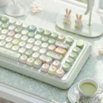 Top-down view of adorable Picnic Bunny MOA profile PBT dye-sub keycaps set, displaying charming pastel hues and whimsical illustrations of bunnies enjoying setup.