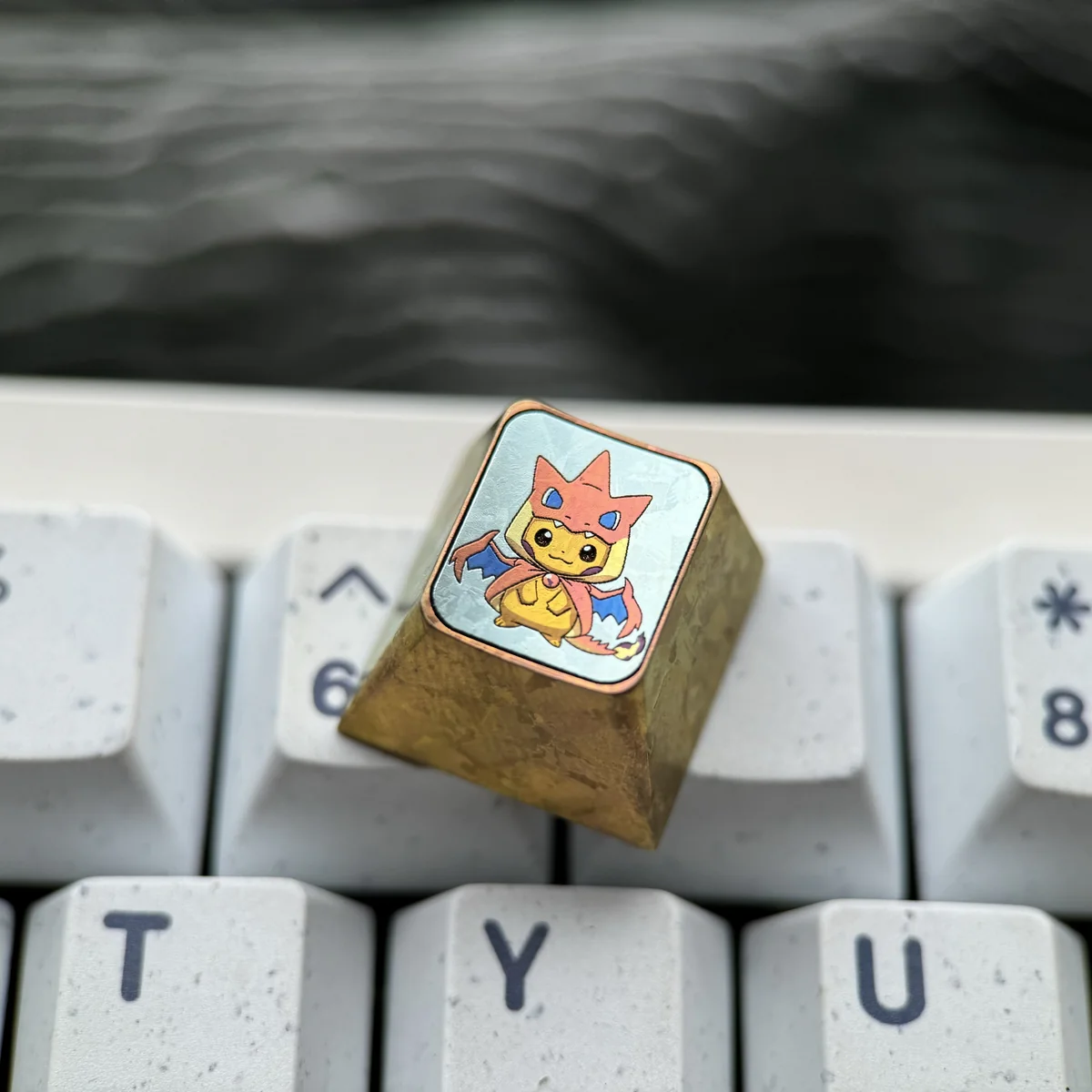 A stunning handcrafted titanium Pikachu Charizard Y ESC keycap, meticulously sculpted with a vibrant fusion design, captured from various premium angles.