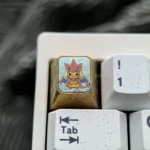 Vibrant handcrafted titanium Pikachu Cosplay Charizard Y ESC keycap, meticulously sculpted, showcasing a premium fusion design for mechanical keyboards.