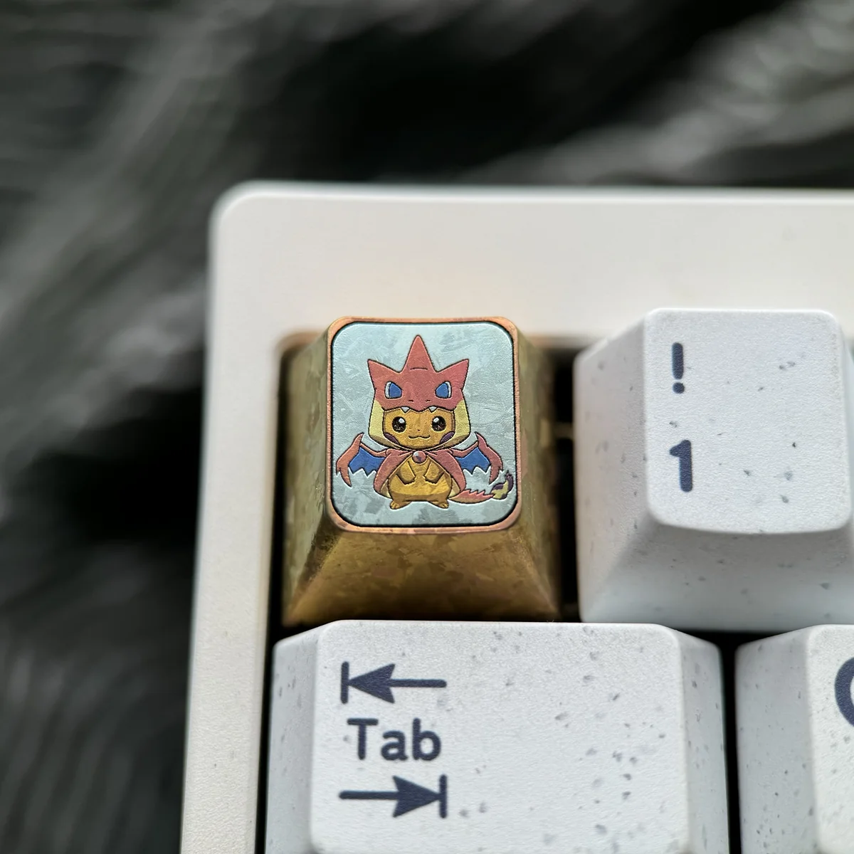 Vibrant handcrafted titanium Pikachu Cosplay Charizard Y ESC keycap, meticulously sculpted, showcasing a premium fusion design for mechanical keyboards.