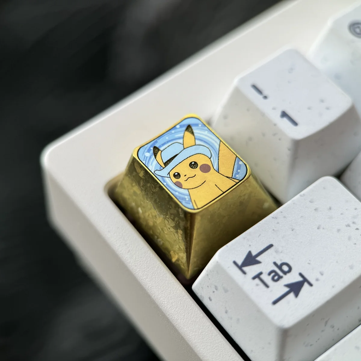 Collectible titanium Pikachu artisan keycap with a charming hat, meticulously crafted and shown from multiple angles. Highlights premium detail.
