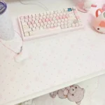 Close-up of the playful pink desk mat, highlighting its unique 'Fish Cake' design and soft pastel hues, perfect for a whimsical, Japanese-inspired workspace.