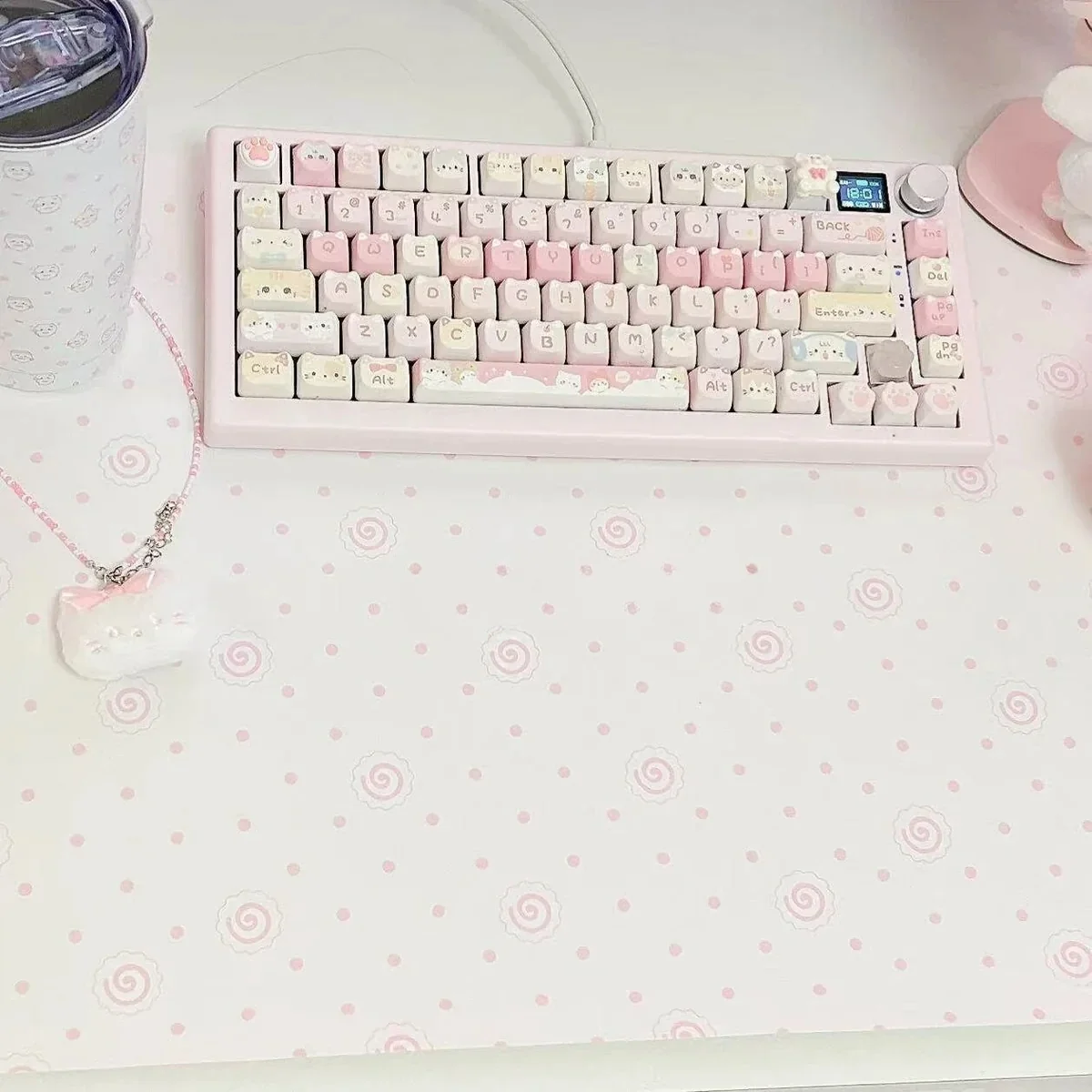 A detailed view of the unique Fish Cake Pink Desk Mat, highlighting its whimsical pastel pink and white design, perfect for a playful, Japanese-inspired.