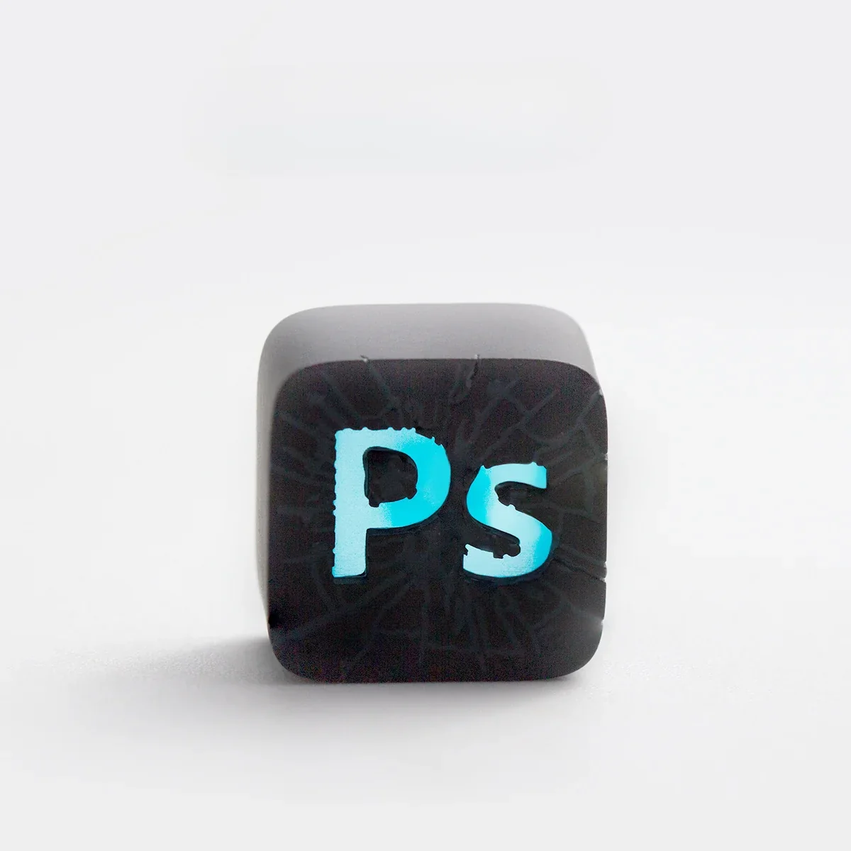 Artisan PS ESC keycap from a unique angle, highlighting its vibrant translucent resin and iconic PlayStation symbols, ideal for retro gaming.